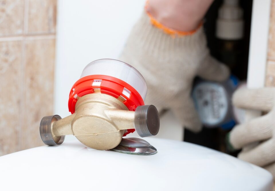 What tool is used to remove the water meter cover